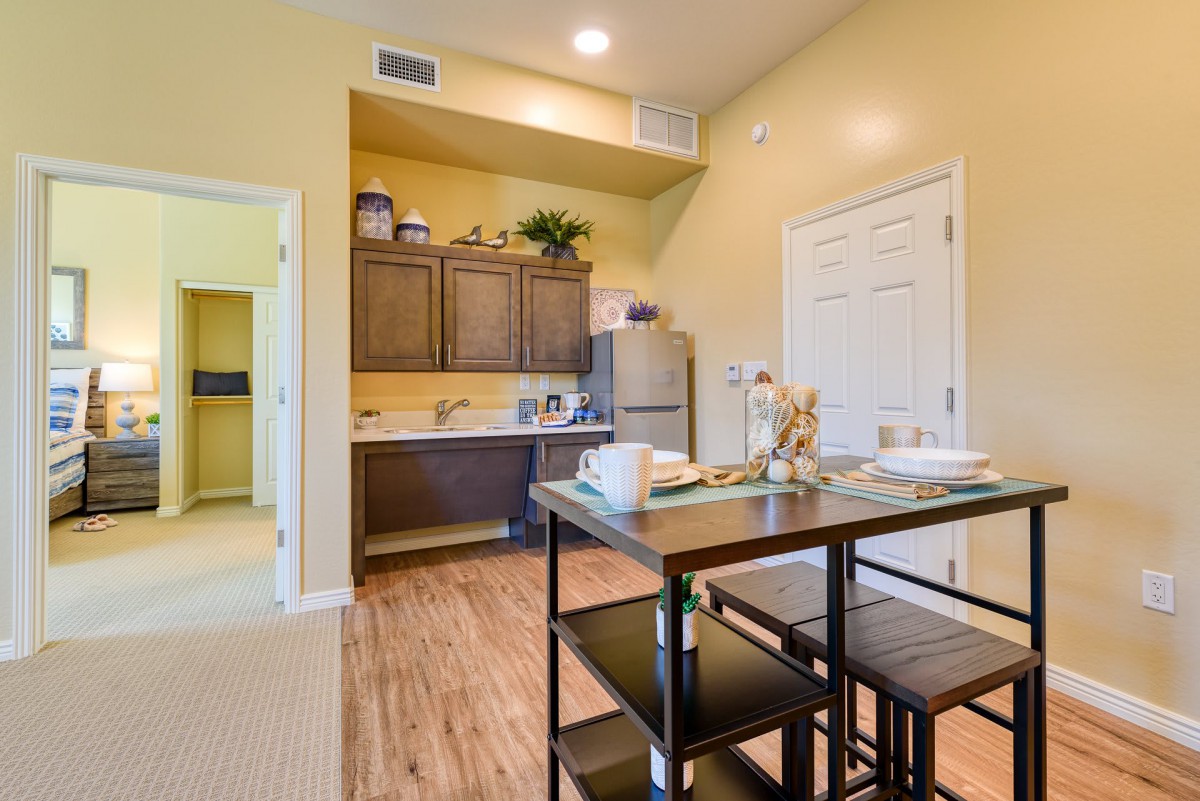 A cozy kitchen and dining area with wooden cabinets and a small dining table.