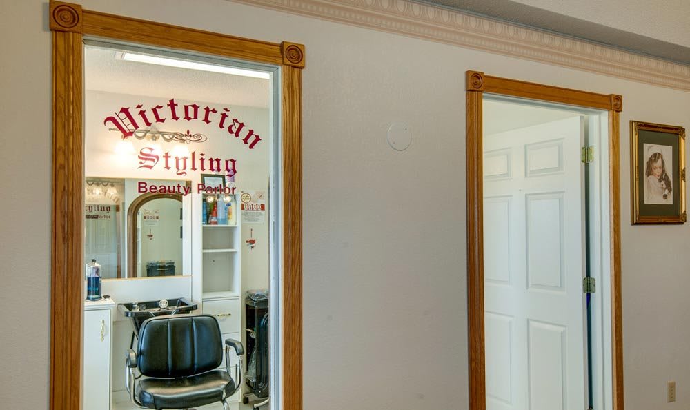 Interior of a vintage-style barbershop with a barber chair and mirror.