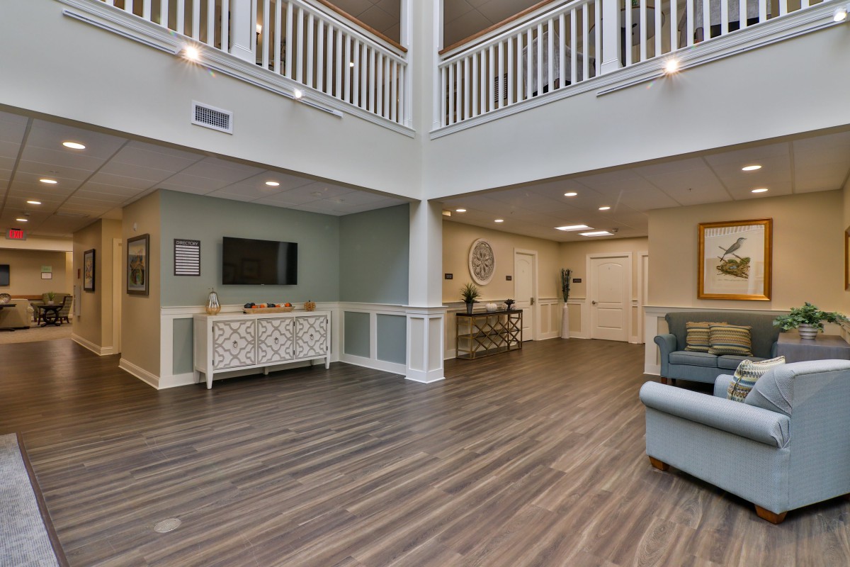 A spacious and modern lobby with stylish flooring and comfortable seating.