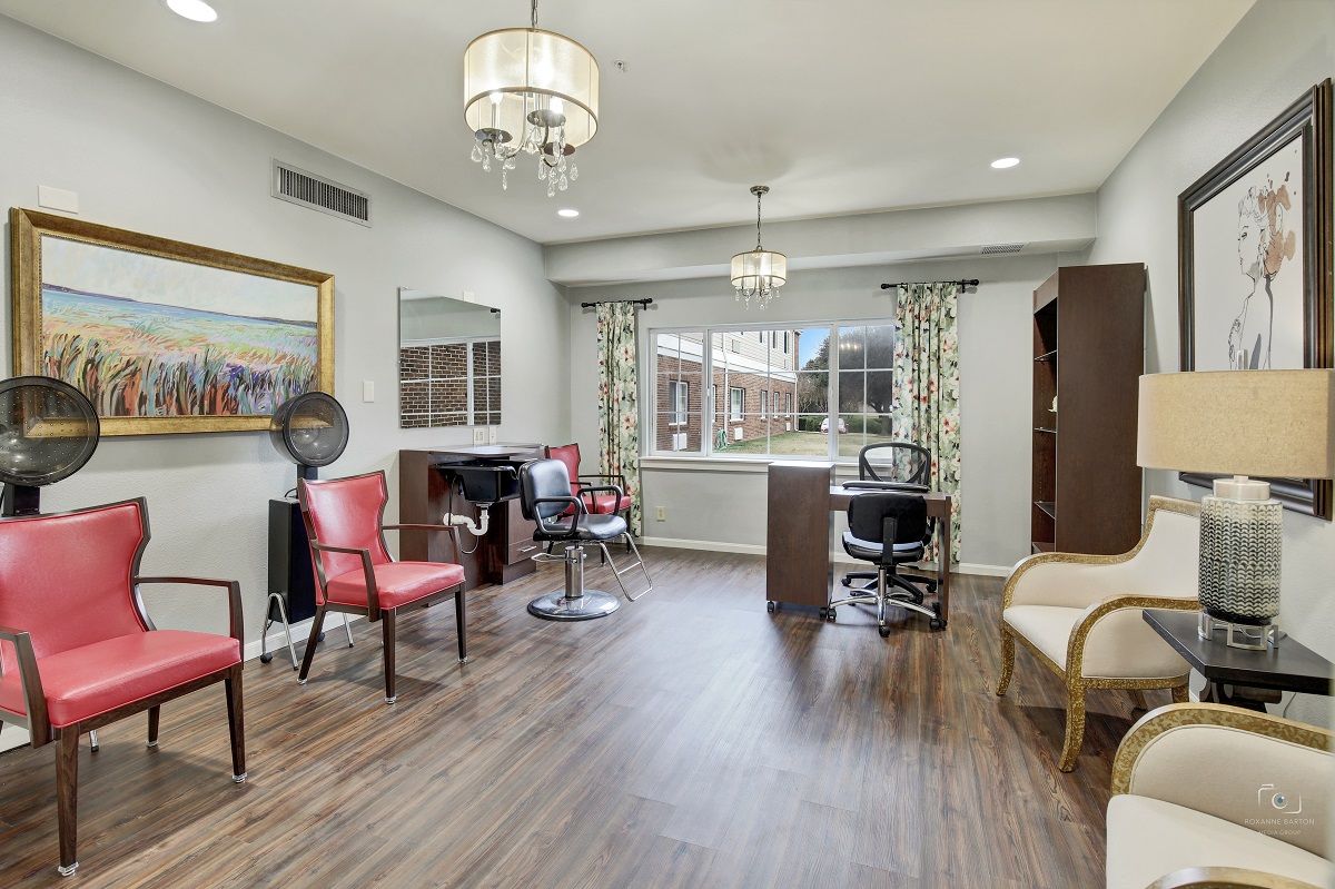 A stylish salon interior with hairdressing stations, chairs, and elegant lighting.