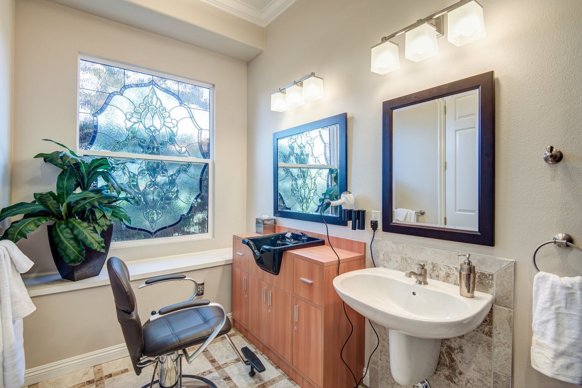 A cozy salon space with a hair washing station and elegant interior design.