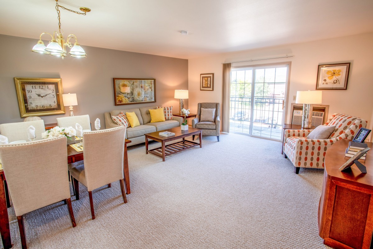 A cozy living and dining area with modern furnishings and a bright, inviting atmosphere.
