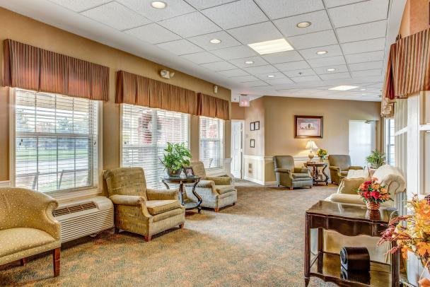 A cozy lounge area with multiple armchairs and large windows.