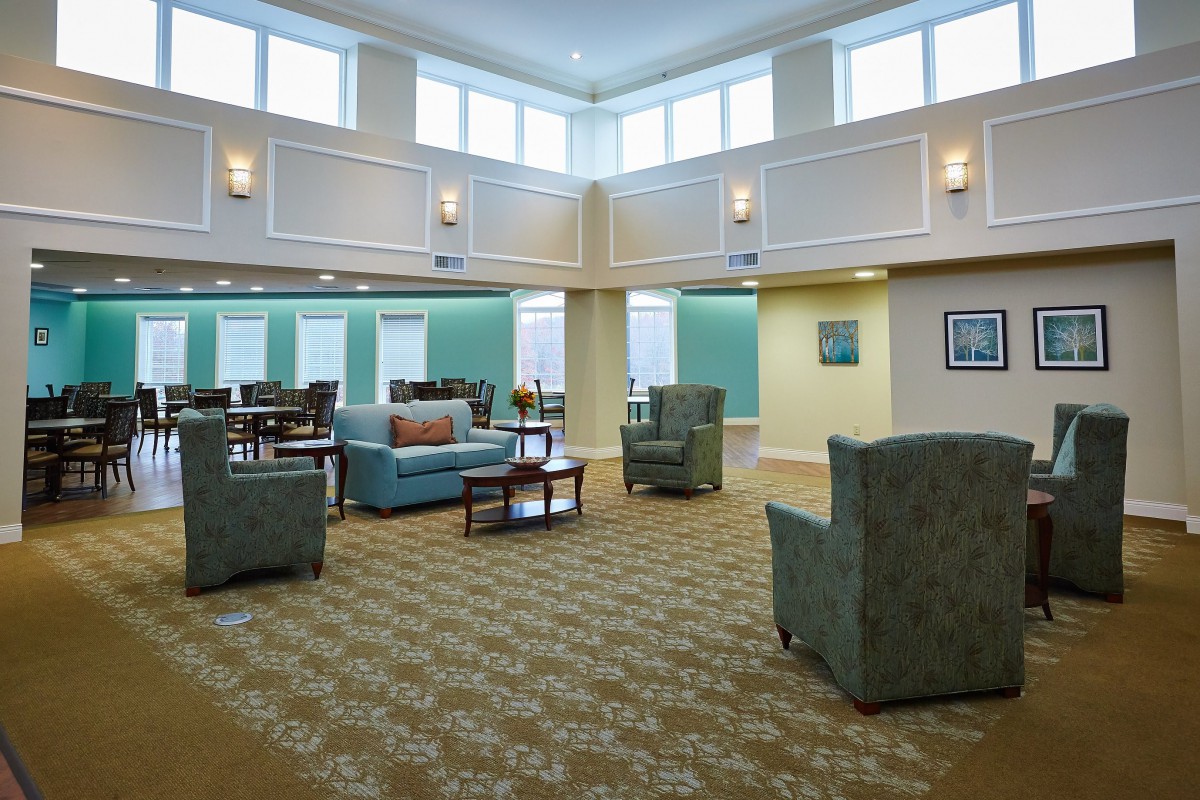 A spacious and well-lit living room with comfortable seating arrangements.
