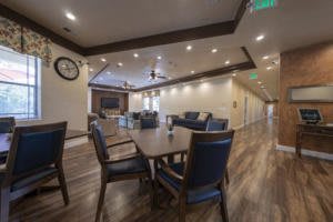 A modern meeting room with a large table, chairs, and comfortable seating.