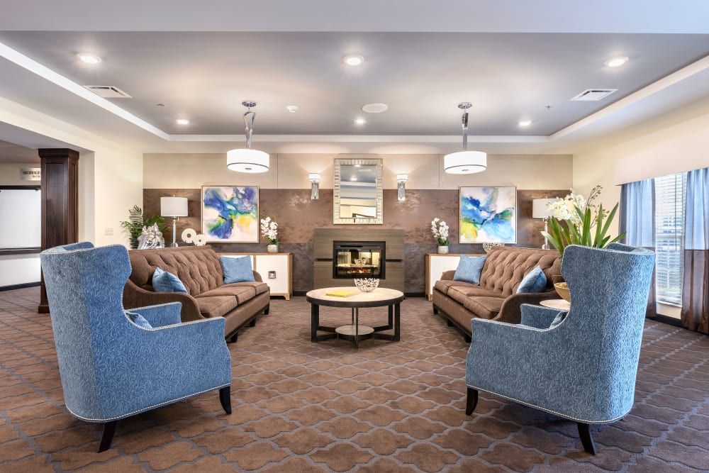 A cozy living room with elegant furnishings and a warm fireplace.