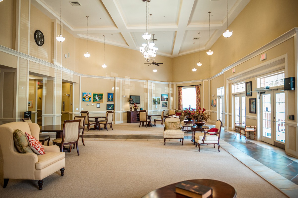 A spacious and well-decorated lobby with elegant seating and chandeliers.