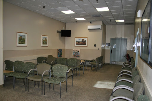 A waiting room in a medical facility, featuring several chairs and a calm, minimalist design.