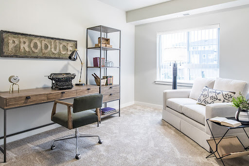A stylish and modern home office featuring a sleek desk, comfortable seating, and ample natural light.