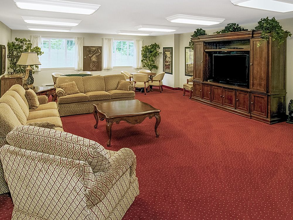 A spacious living room with comfortable seating and a large television.