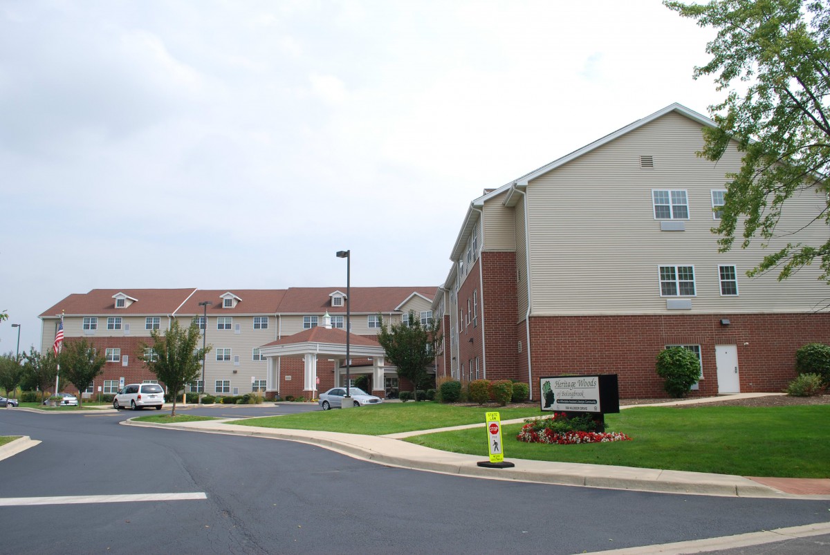 A residential apartment complex with a driveway leading to the entrance.