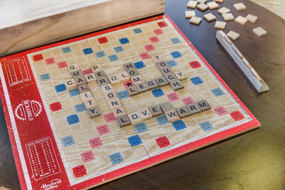 A Scrabble board with several words spelled out using letter tiles.