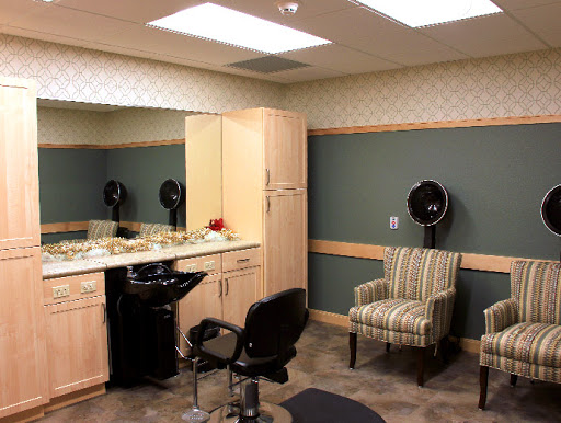 A modern hair salon interior featuring styling chairs, mirrors, and a cozy waiting area.