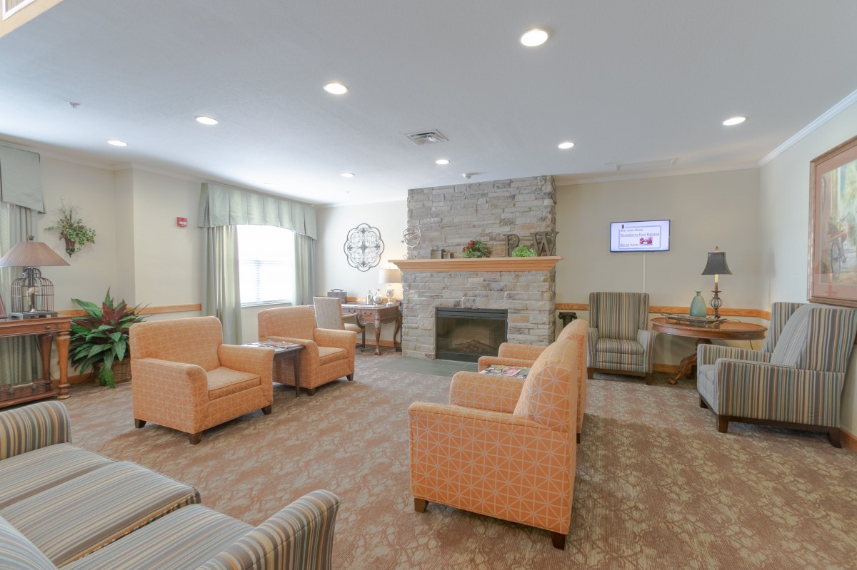 A cozy living room with comfortable seating and a fireplace.