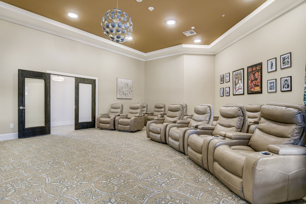 A luxurious home theater featuring comfortable recliners and modern decor.
