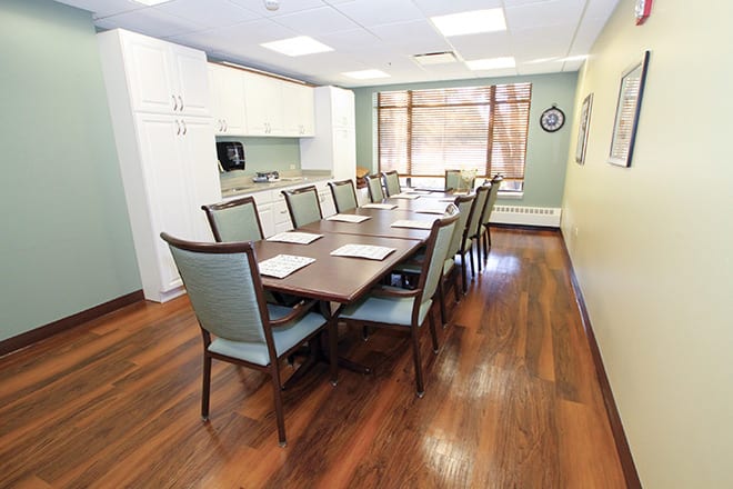 A well-lit conference room with a long table and chairs arranged for a meeting.