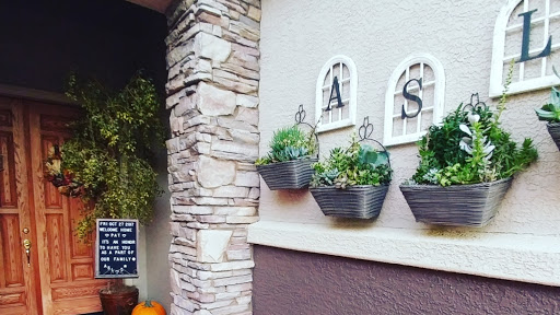 Charming exterior with hanging planters and decorative letters.