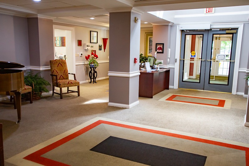 A well-decorated lobby with a reception desk and seating area.