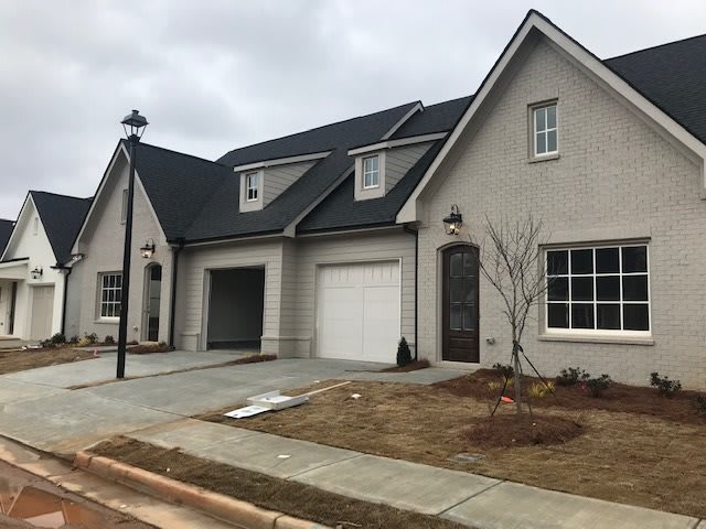 A modern suburban house with a spacious driveway and attached garage.