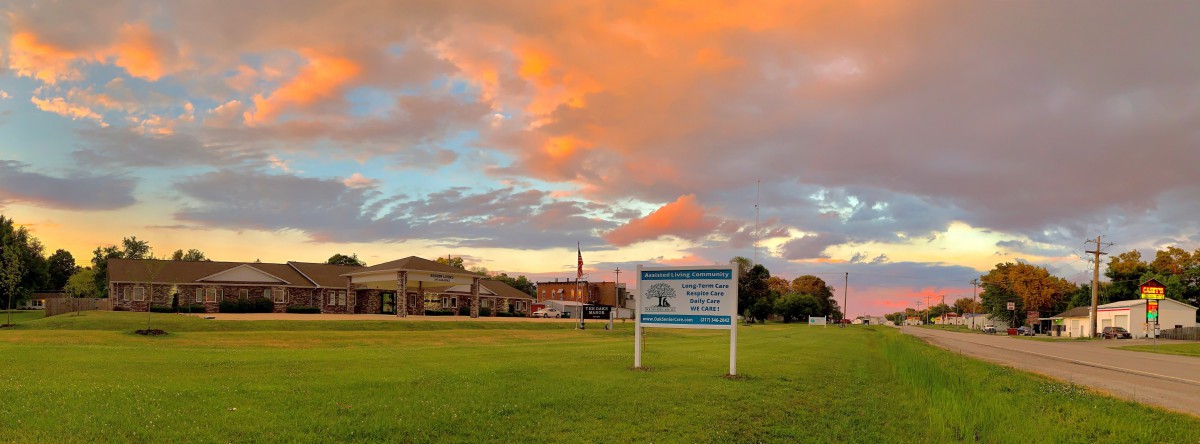 A school building and sign under a vibrant sunset sky.