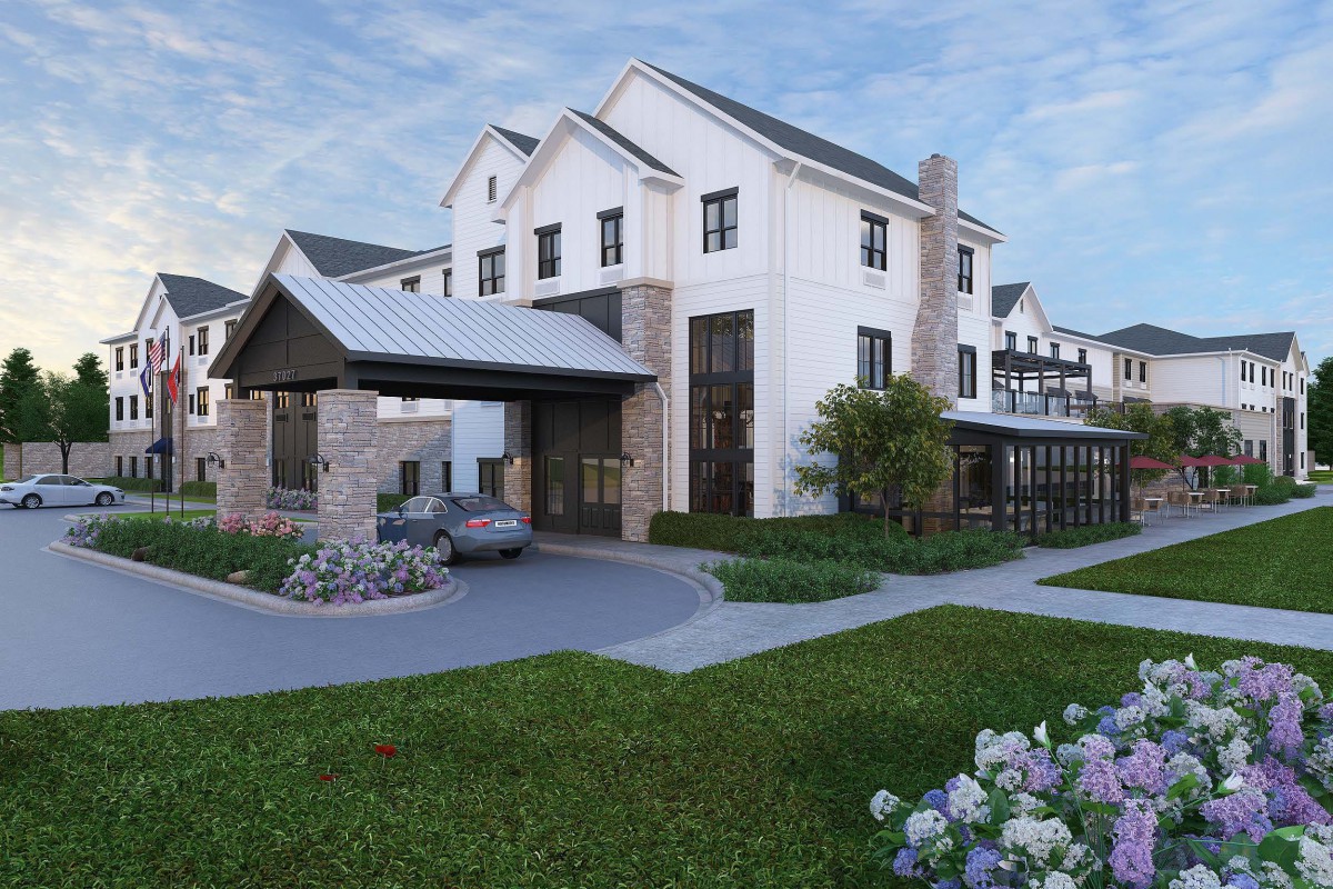 A modern residential house with a landscaped garden and driveway.