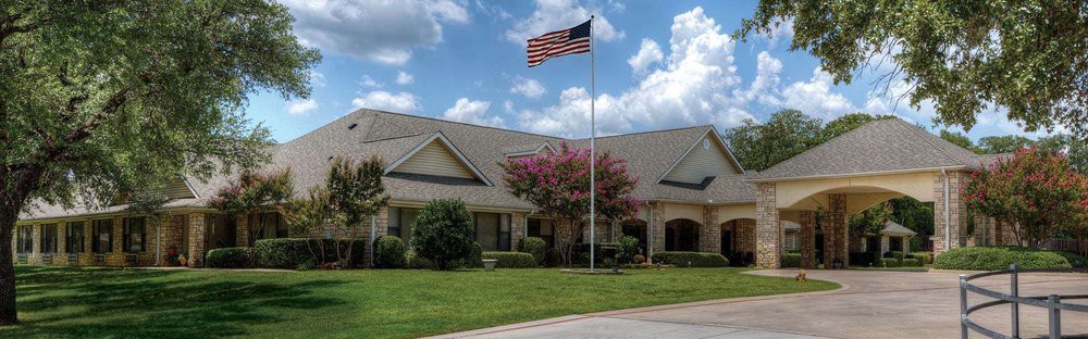 A suburban house with an American flag on a sunny day.