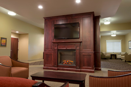 A warm and inviting living room featuring a modern fireplace and a mounted television.