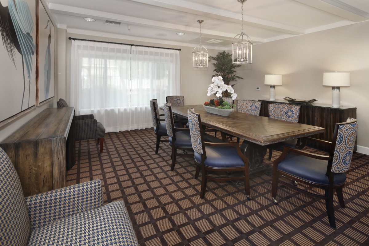 A well-appointed dining room with a large table, chairs, and elegant decor.