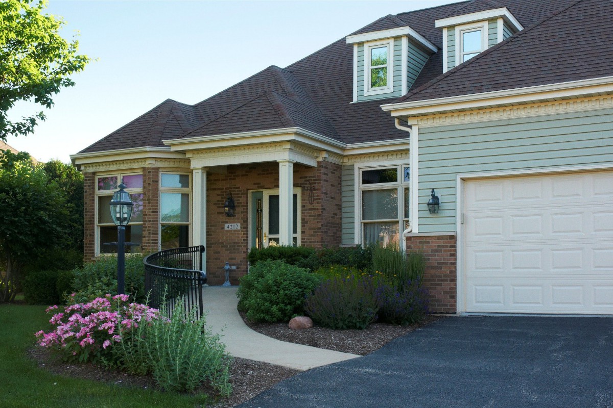 A suburban house with a well-maintained garden and attached garage.