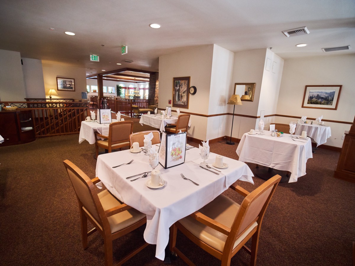 A cozy restaurant dining area with neatly arranged tables and chairs.