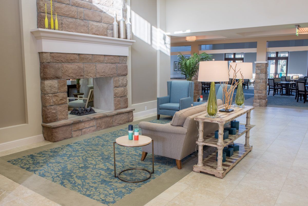 A modern living room with elegant furnishings and a cozy fireplace.