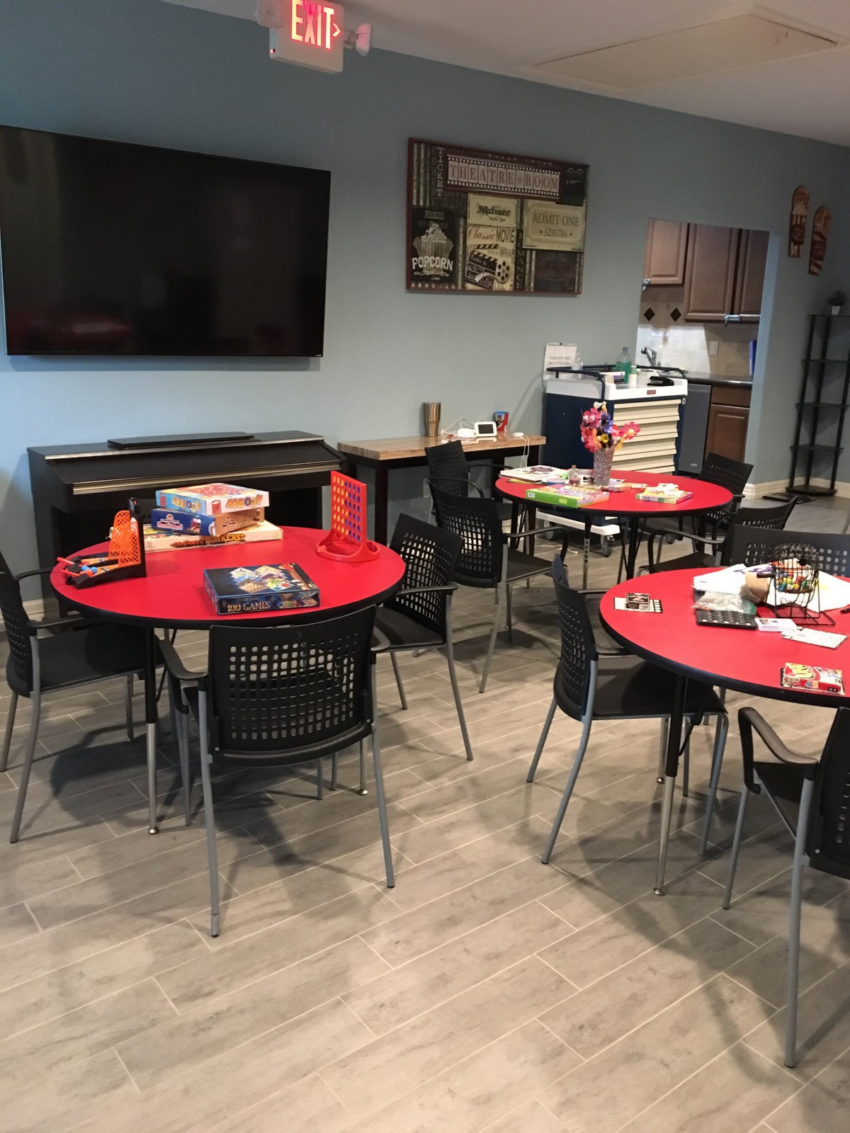 A cozy room with red tables set up for board games.