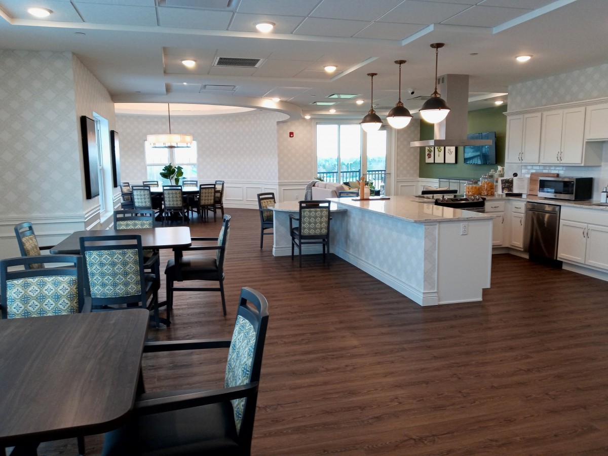 A modern cafe interior with tables, chairs, and a counter area.