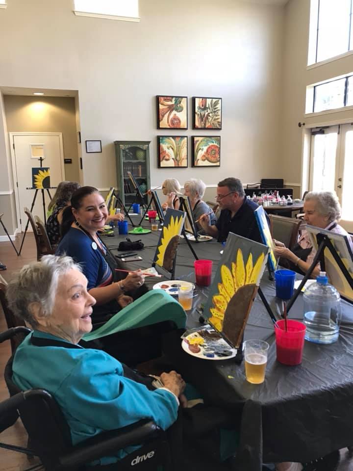 A group of seniors participating in an indoor art class.