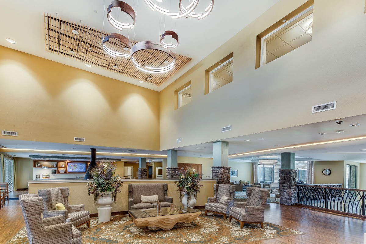 A spacious and modern hotel lobby with elegant furniture and stylish lighting fixtures.