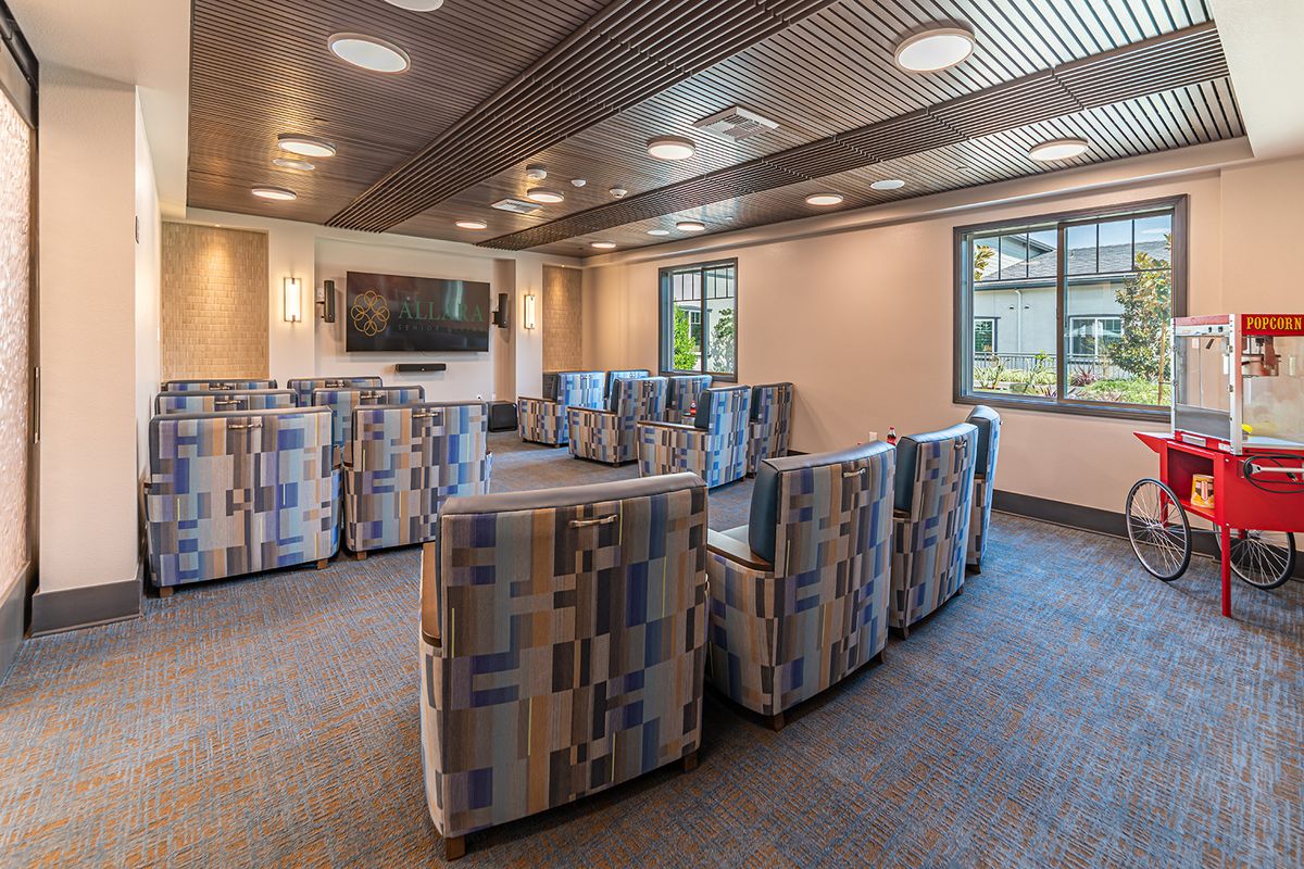 A modern lounge area with comfortable seating and a TV screen, ideal for meetings and relaxation.