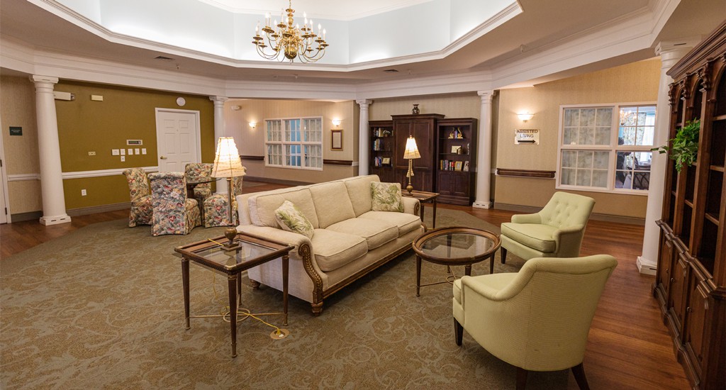 A cozy living room with elegant furniture and a chandelier.