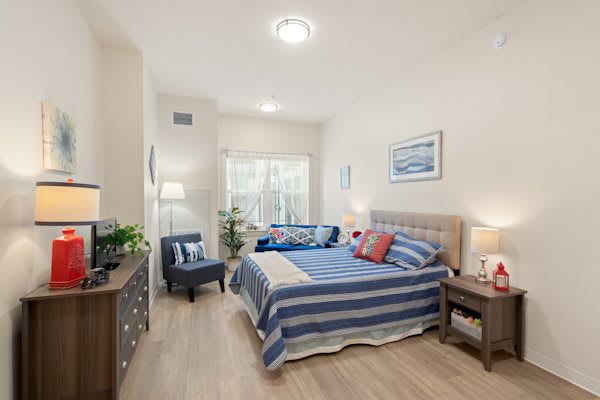 A modern bedroom with a striped bedspread and stylish decor.