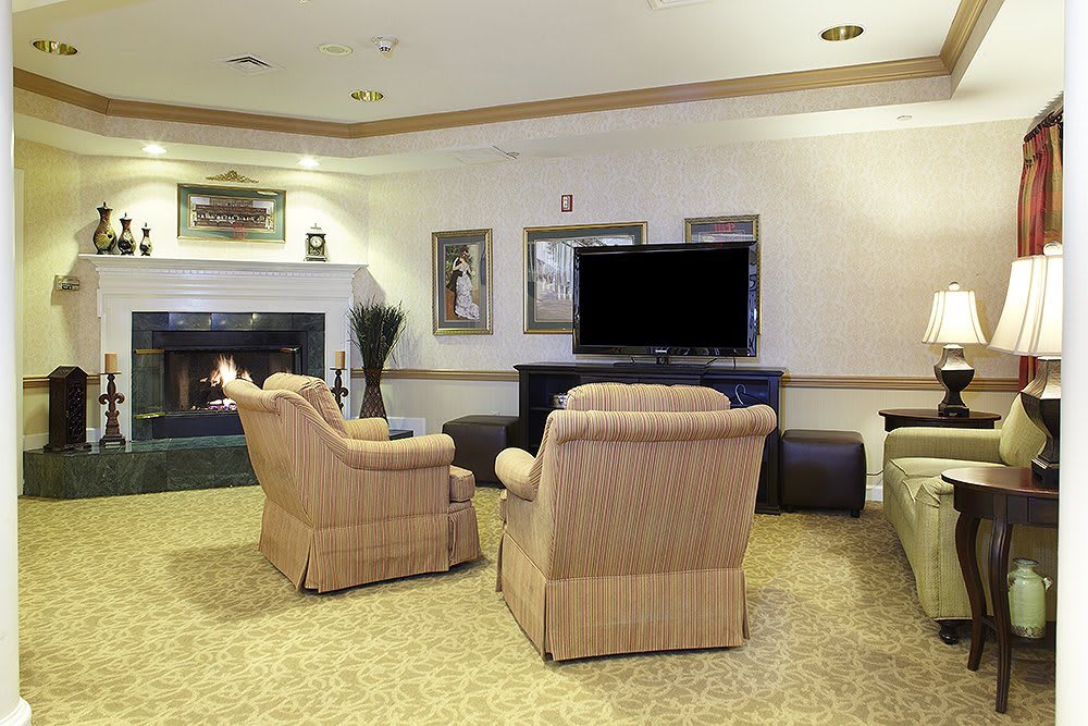 A cozy living room with comfortable seating and a large television.