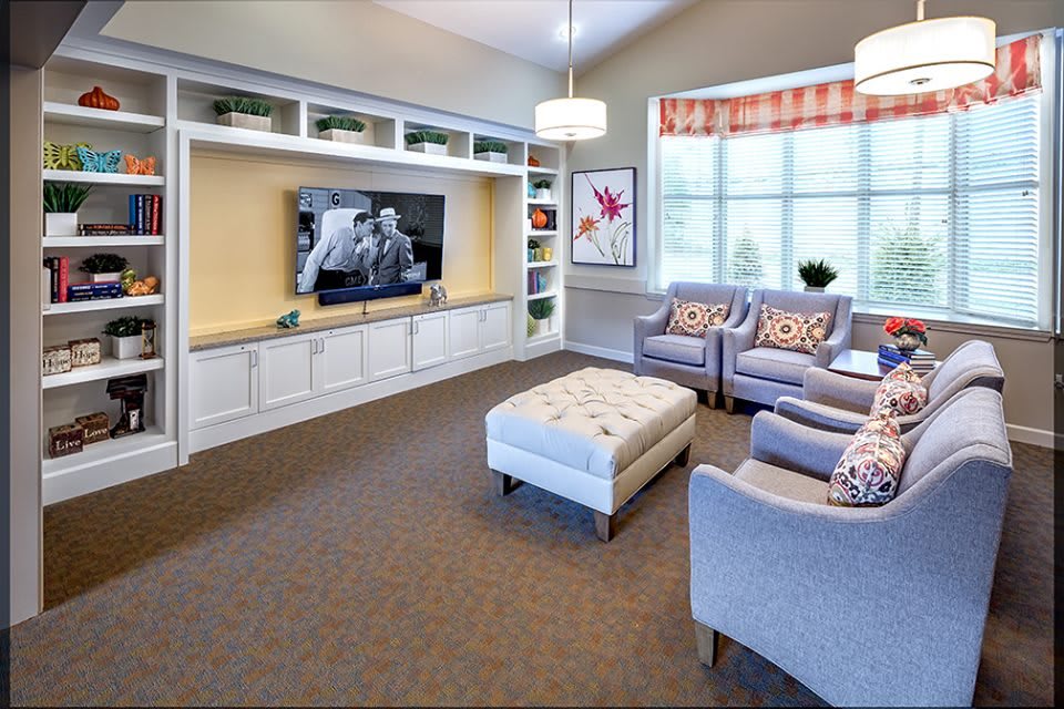 A cozy living room with comfortable seating and a large TV.