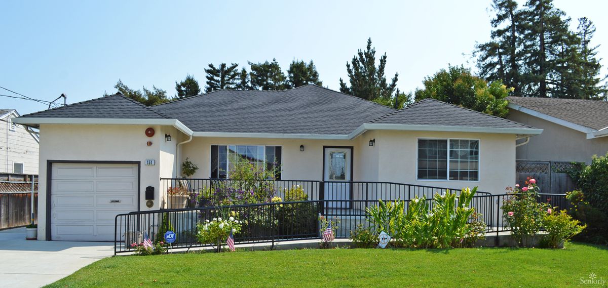 A single-story house with a well-maintained front yard and garden.
