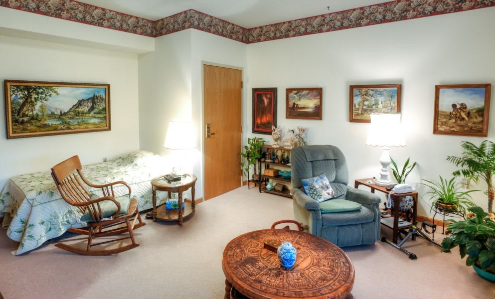 A cozy living room with comfortable seating and various decorative items.