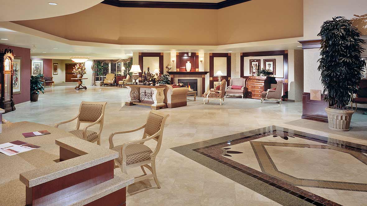 A spacious and elegantly designed hotel lobby with multiple seating areas and stylish decor.