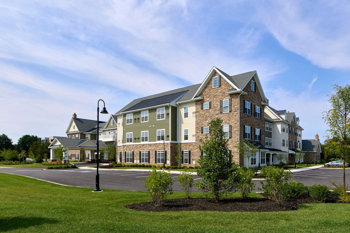A modern residential apartment complex surrounded by greenery.