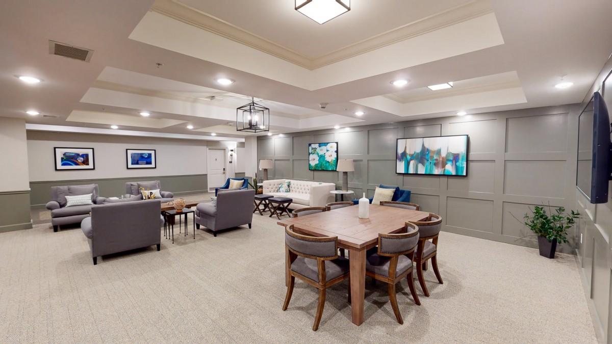 A modern living room with comfortable seating, stylish decor, and ample lighting.