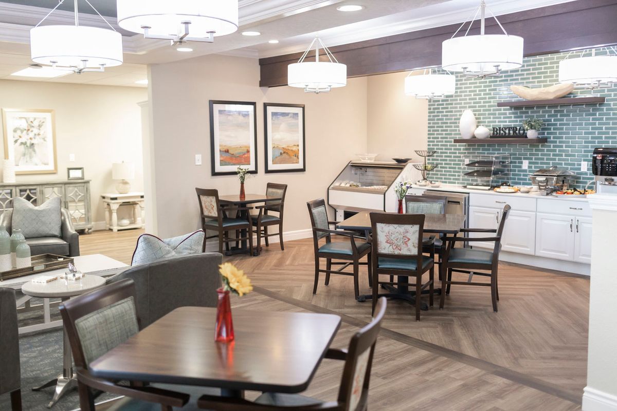 A modern dining area with stylish tables and chairs, decorated with contemporary lighting fixtures.