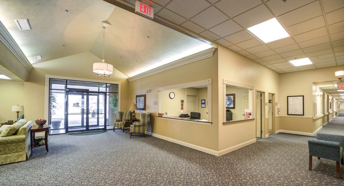 A spacious lobby with a reception desk and seating area near the entrance.