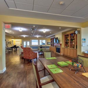 A cozy living room and dining area with wooden furniture and a warm atmosphere.