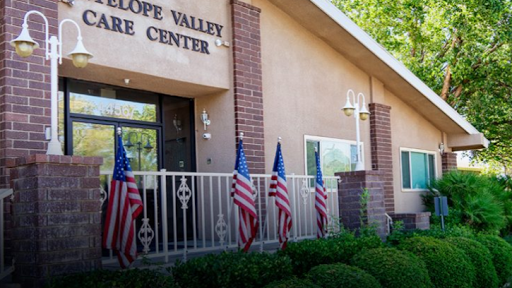 The Antelope Valley Community Center features a welcoming entrance adorned with American flags.