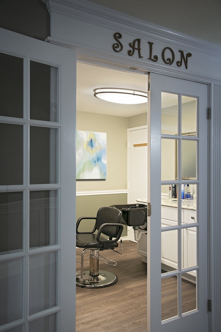 Interior view of a modern salon with stylish chairs and artwork.